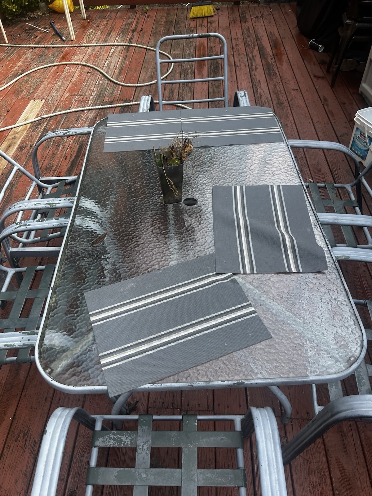 Glass patio table and 6 chairs, 2 swivel & 4 stationary, all black metal