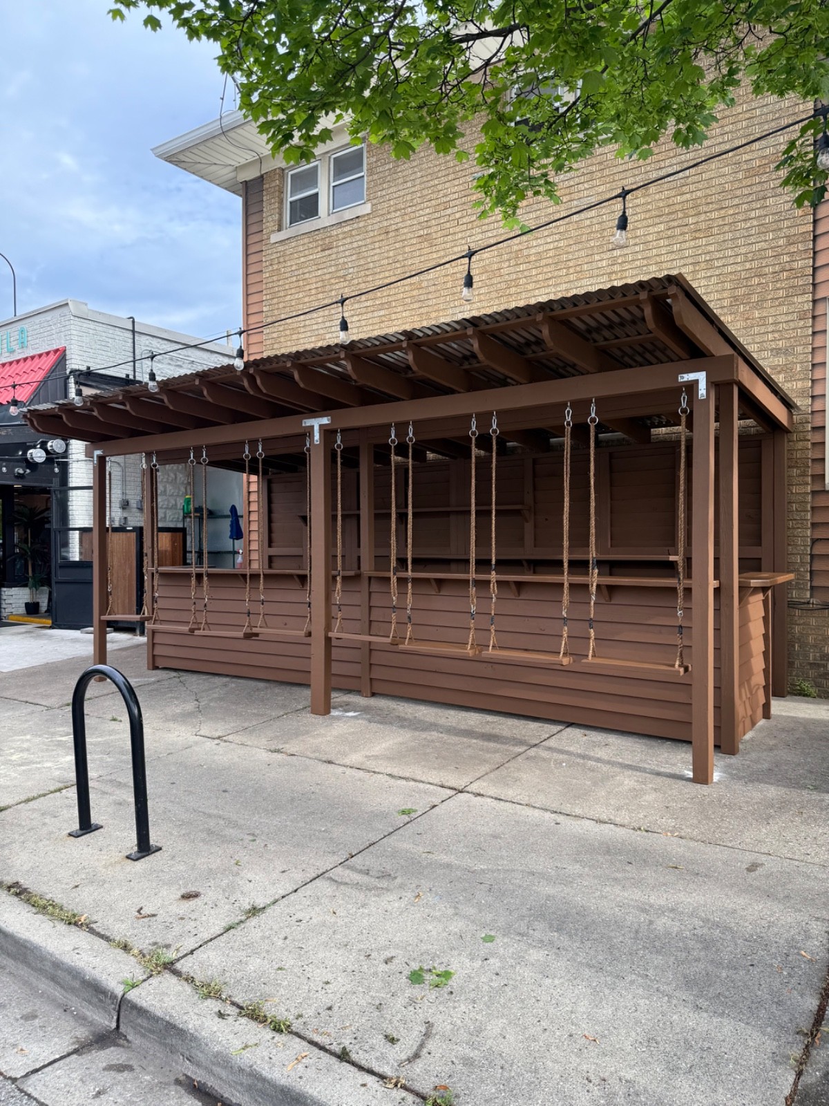 outdoor bar with canopy and swings